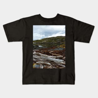 Dead trees lying at the sea Kids T-Shirt